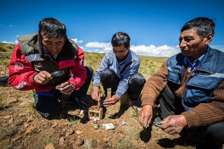 Expert farmers or "Yapuchiris" Enrique Huallpa, Félix Paredes, and Atiliano Tiñini analyzing soil in Bolivia. Photo credit: Jules Tusseau