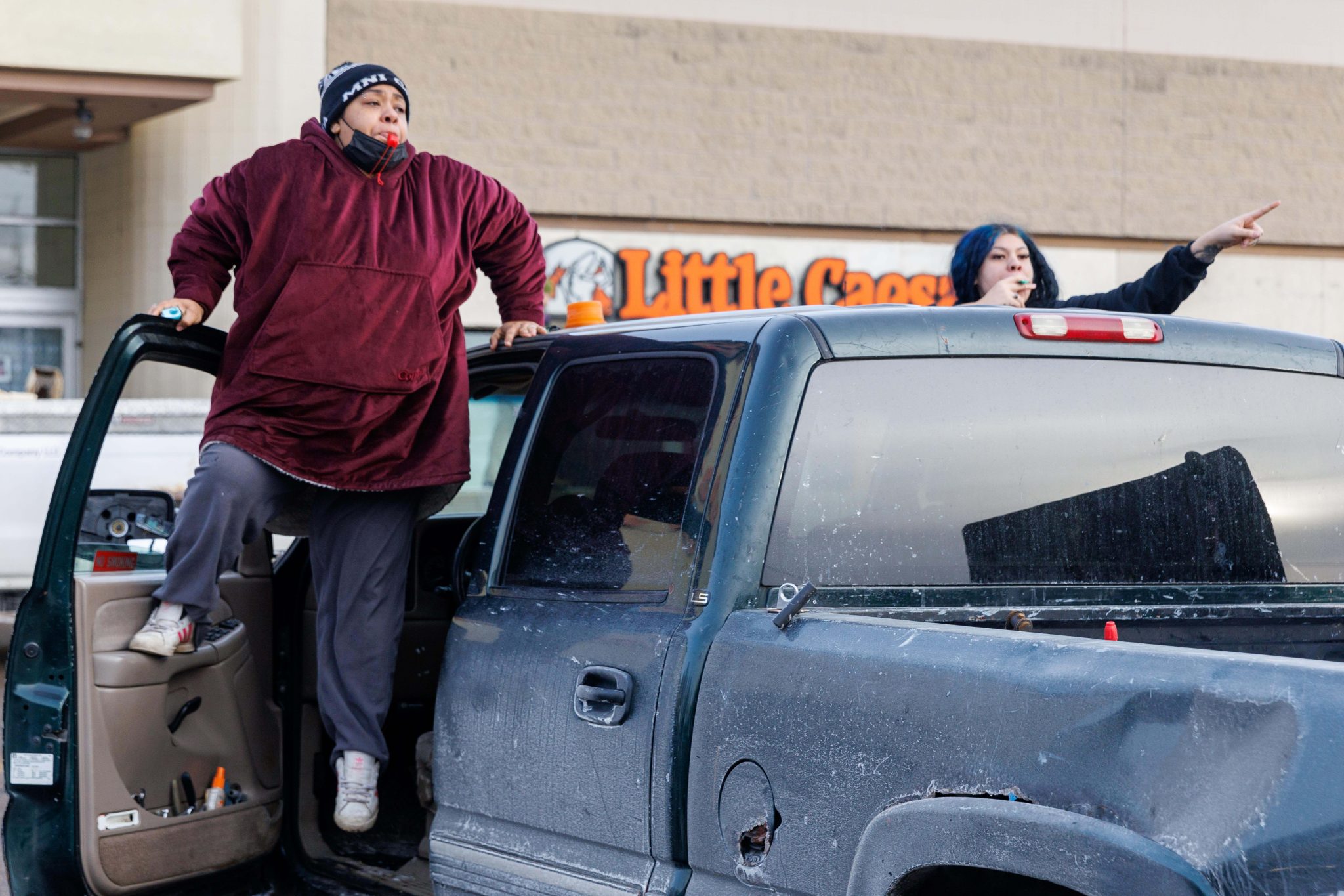 Two women in Saint Paul alert workers that federal agents are nearby. Photo credit: John Rudoff, Associated Press