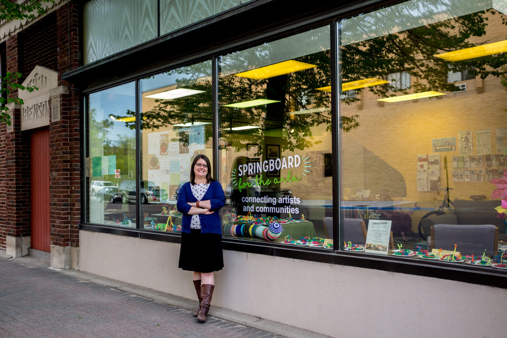 woman standing infront of an art shop