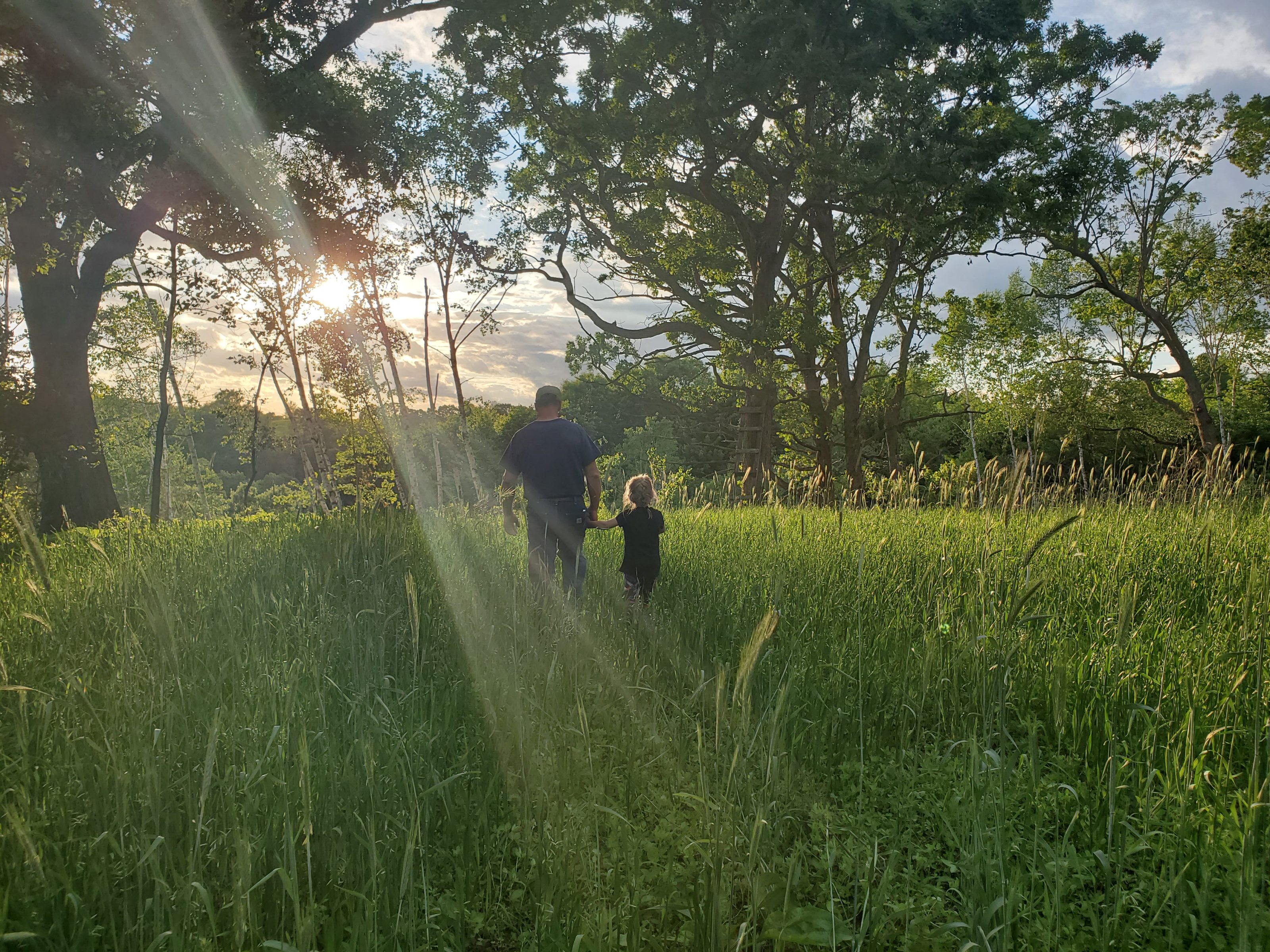 Alanna's husband and daughter walking on the land together.