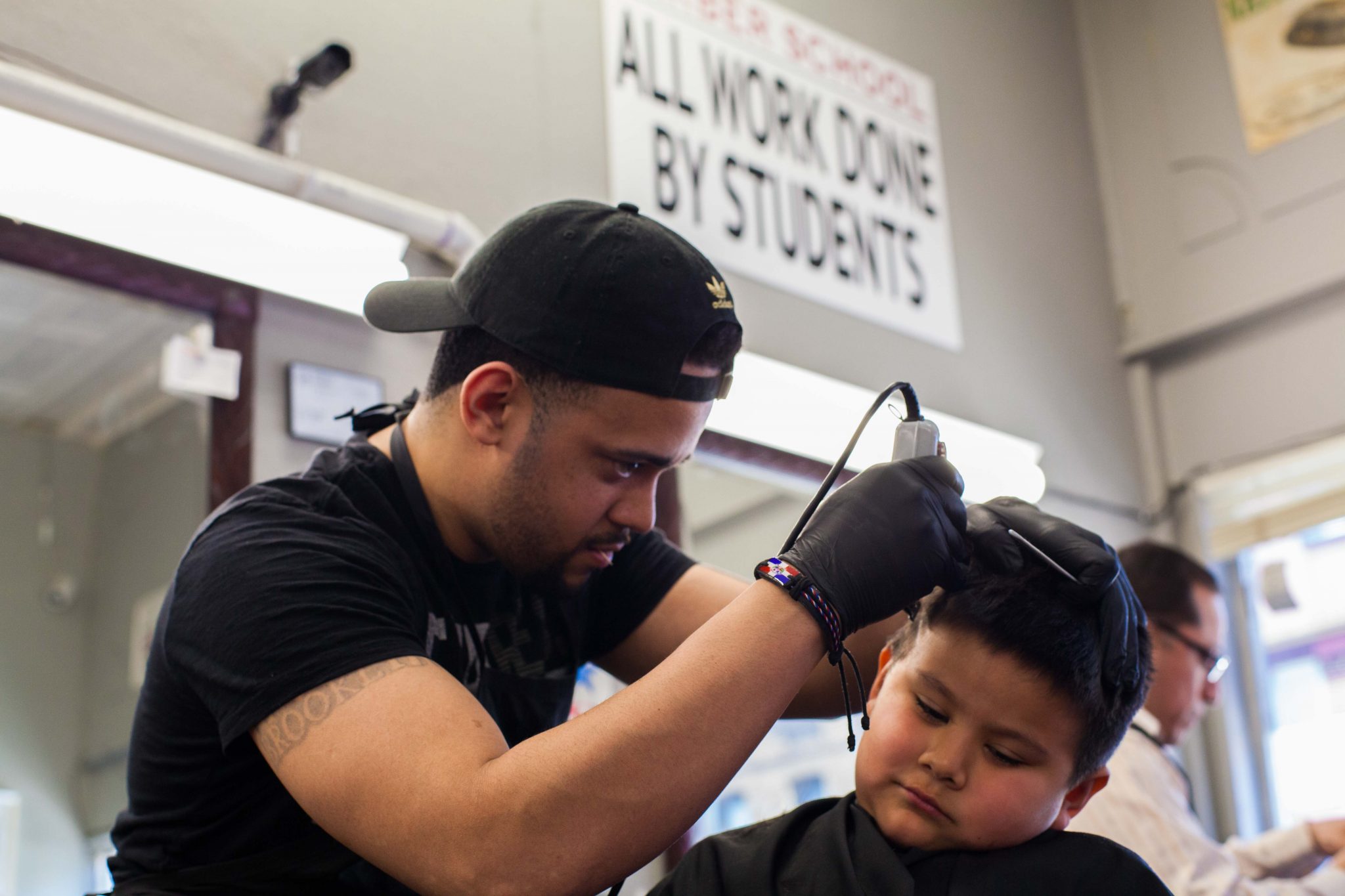 Man cutting a young boys hair