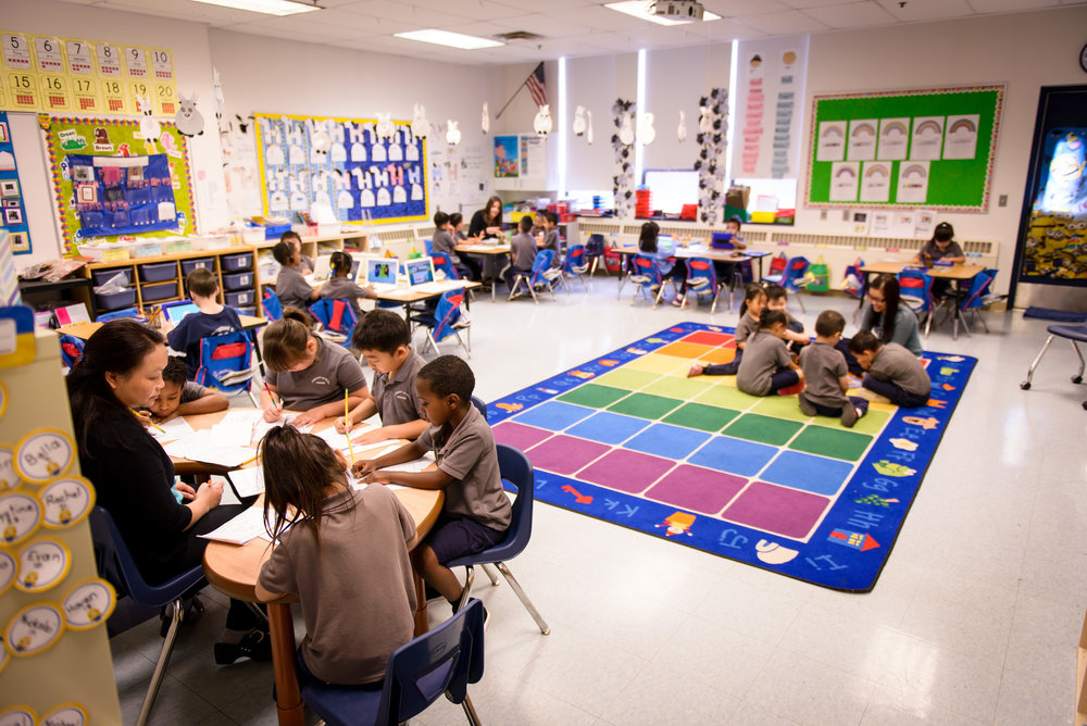 Elementary kids sitting down and doing their school work