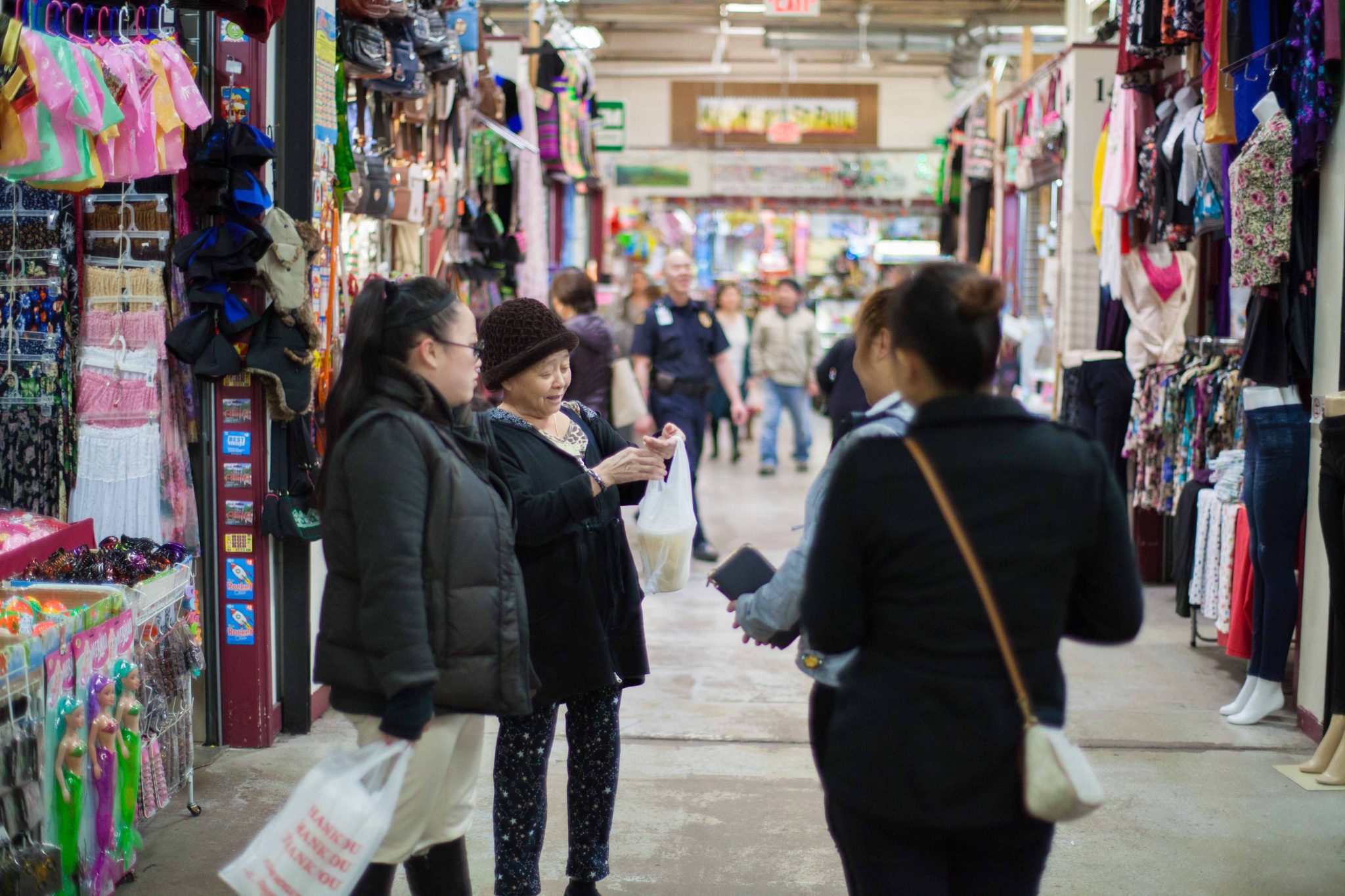 Tuulada Hmong 2 peeople shopping at an indoor Hmong market