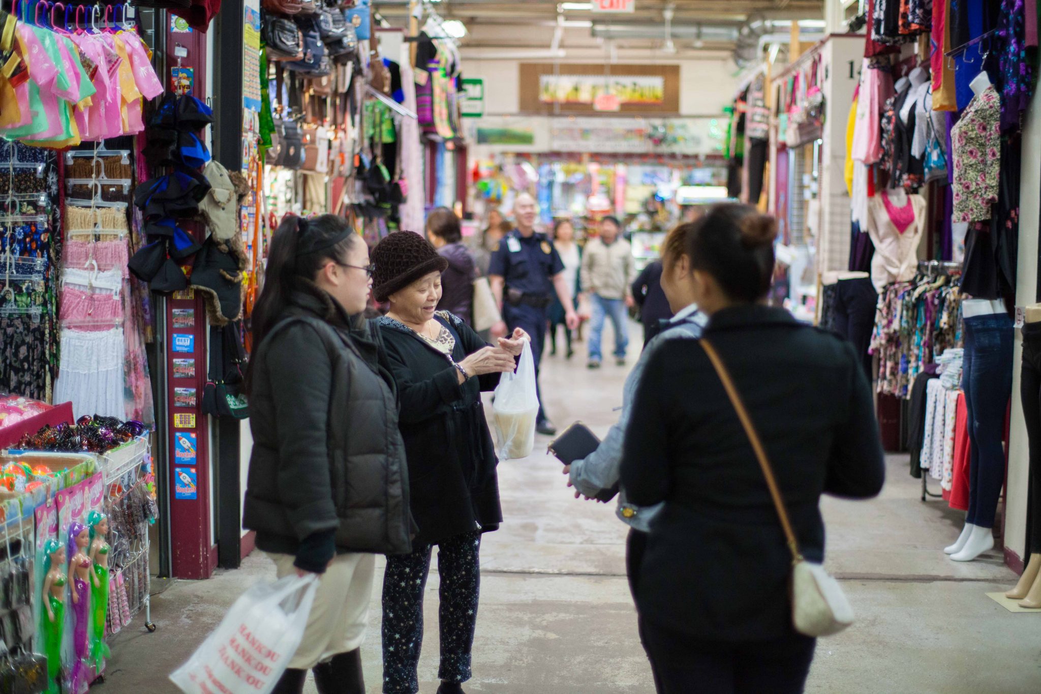 peeople shopping at an indoor Hmong market