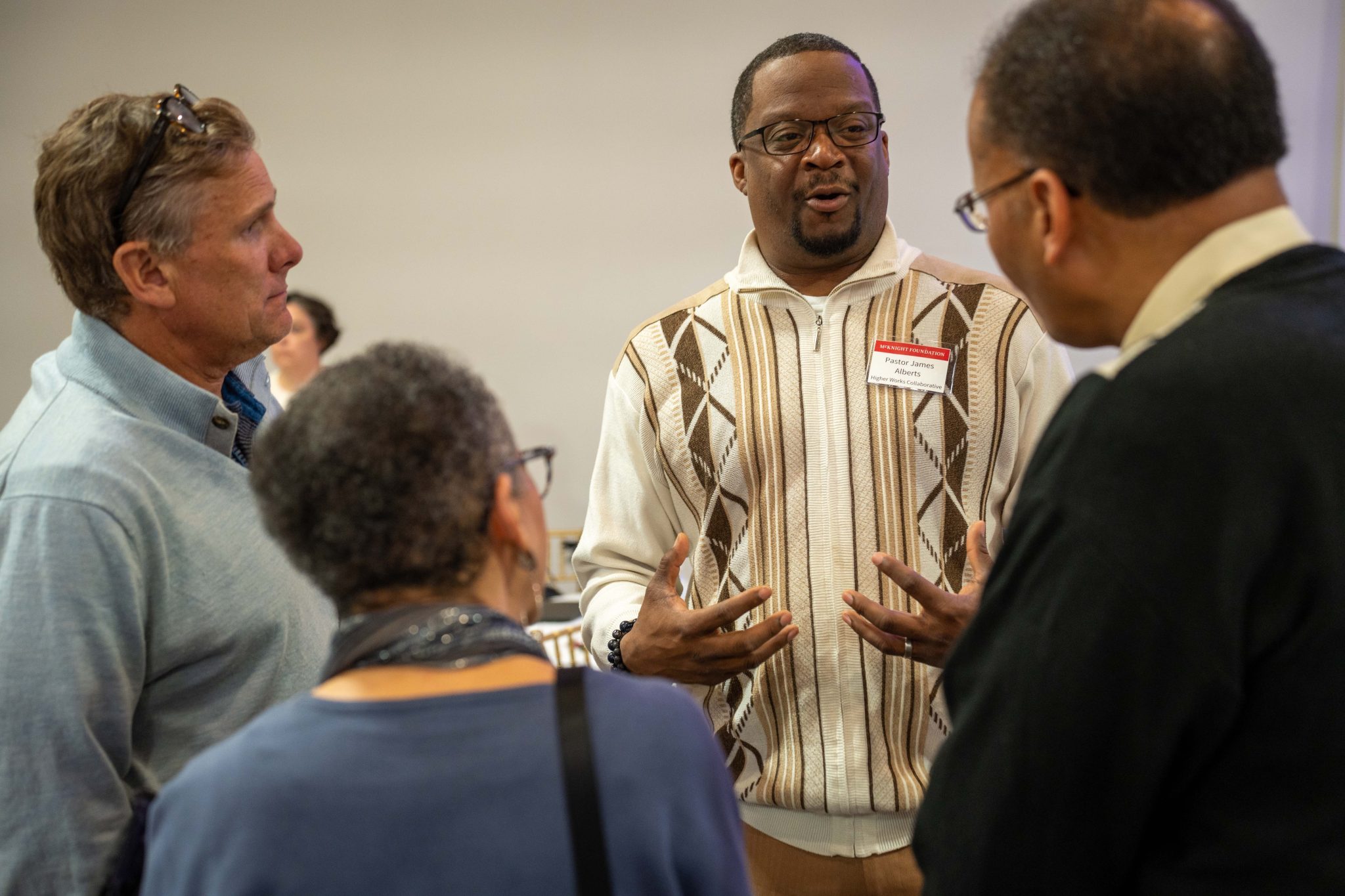 Pastor James Alberts II (center) shares his perspectives with McKnight board members during a gathering in St. Cloud.