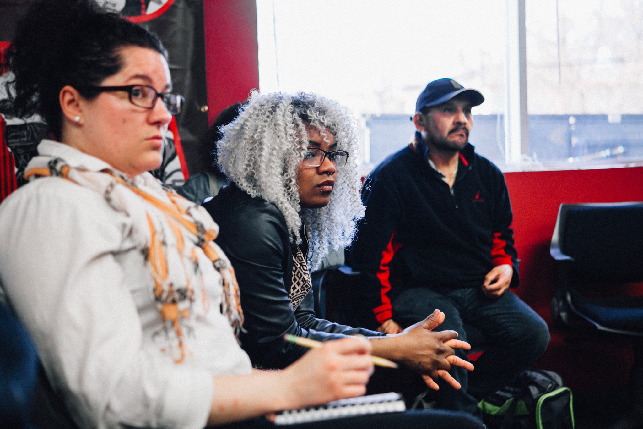 Inquilinxs Unidxs members listen while a fellow renter describes her struggle with substandard housing conditions.