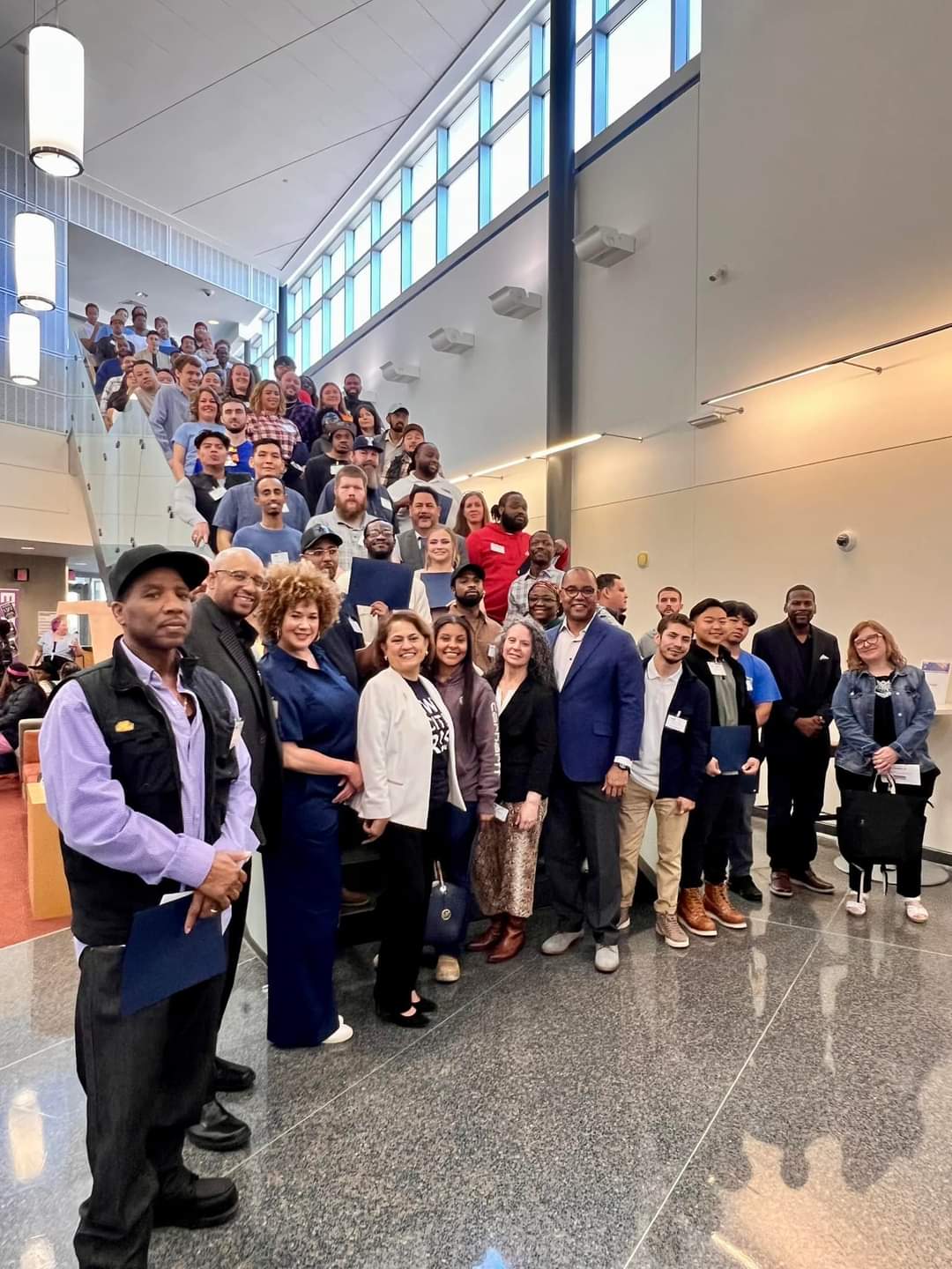 Graduates of Building Strong Communities in 2024, with Rick in the middle of the pack.