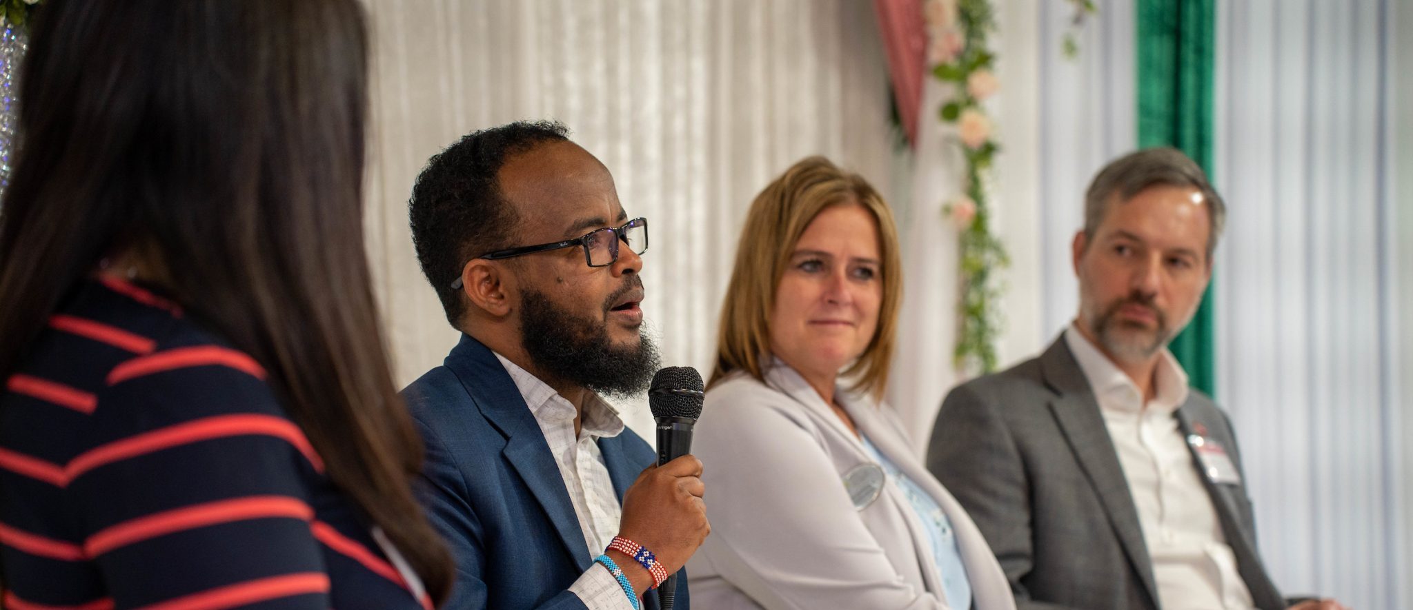 Jama Mohamed with Morgan Family Foundation speaks on a panel in St. Cloud with fellow community leaders Greta Stark-Kraker at Central Minnesota Community Foundation and Matt Varilek at Initiative Foundation.