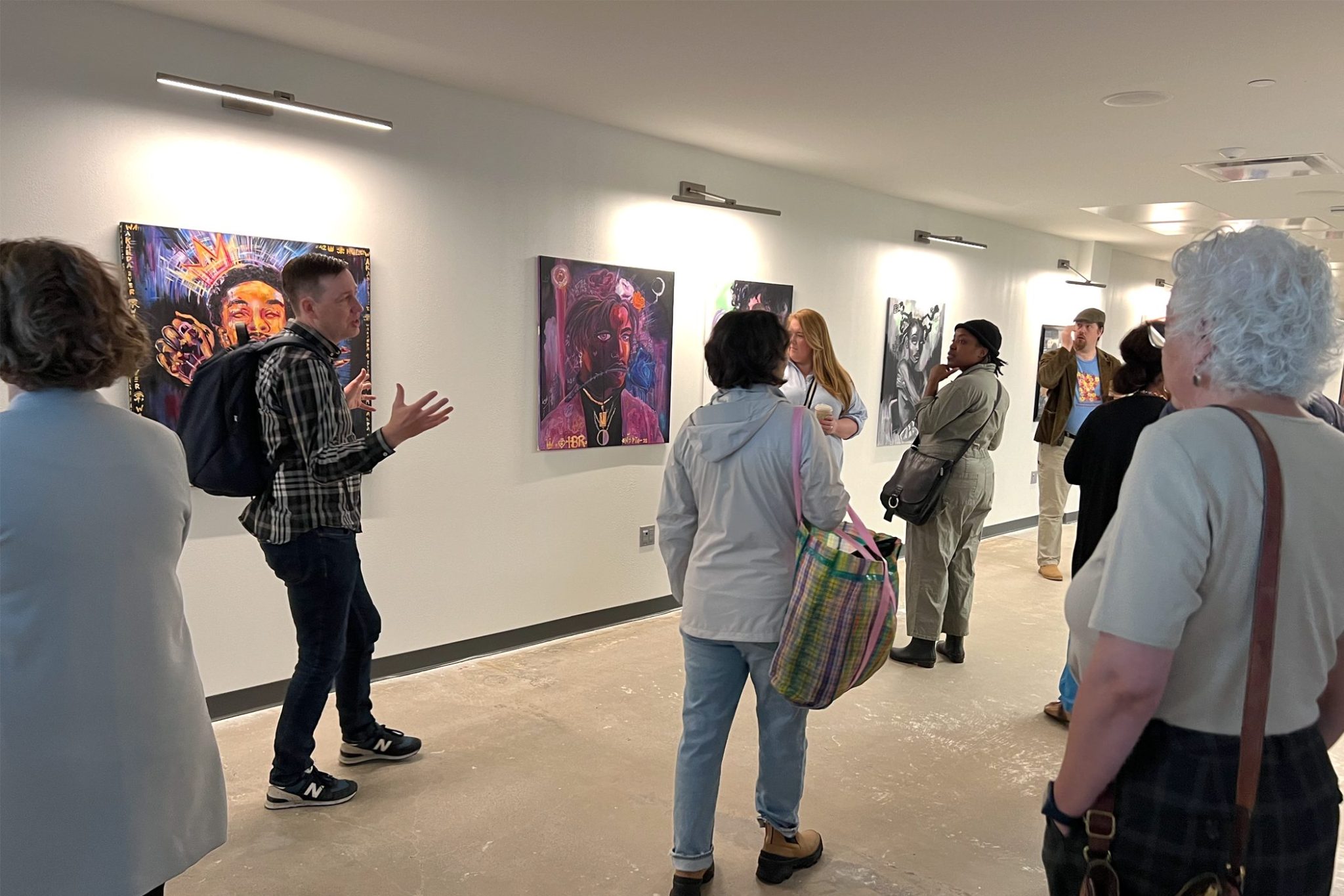 A group of people tour an art gallery