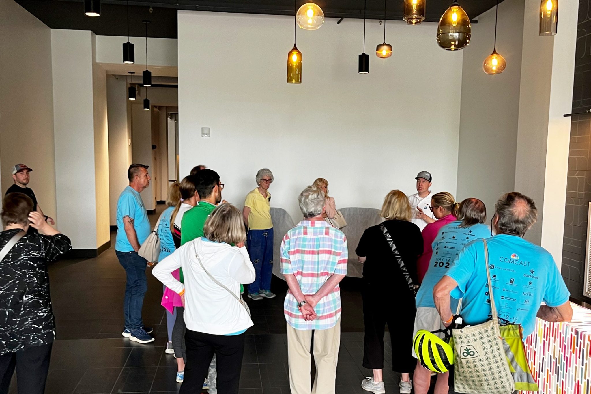 A group of 15 people learn about the restoration of the Historic Coliseum building during a tour during Doors Open Minneapolis in 2024